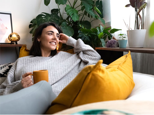 A woman relaxing in a comfortable, peaceful indoor environment